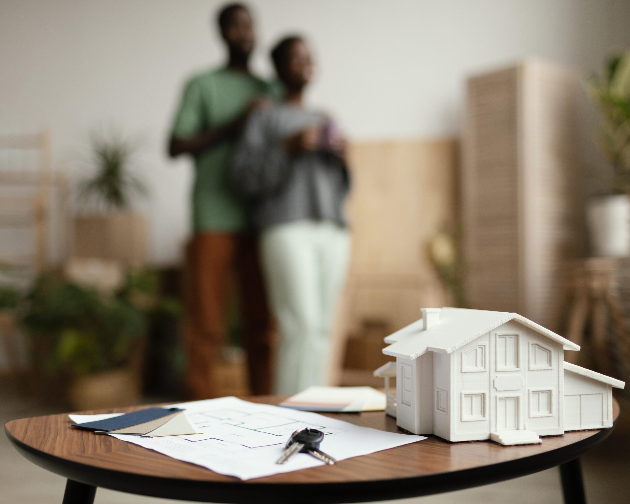 propert-new-home-keys-plan-table-with-defocused-couple